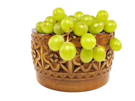 grapes in wooden bowl on a white background 
    の写真素材