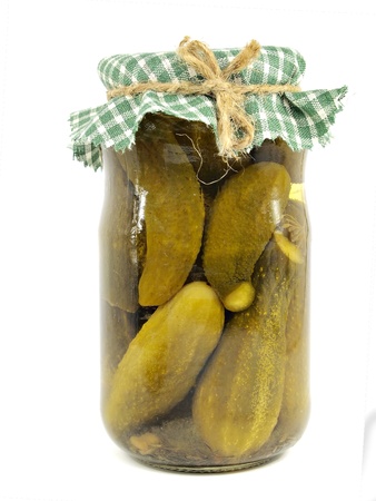 Glass jar with pickled cucumbers on a white background     の写真素材