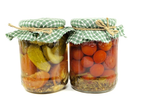 pickled cucumbers and tomatoes canned in glass jar on  a white background 
の写真素材