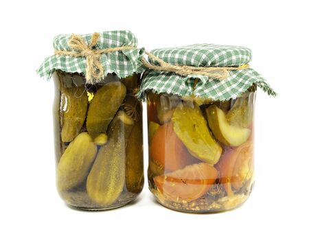 pickled cucumbers and tomatoes canned in glass jar on  a white background 
の写真素材