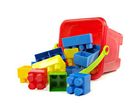 plastic building blocks in red toy pail on a white background 
  の写真素材