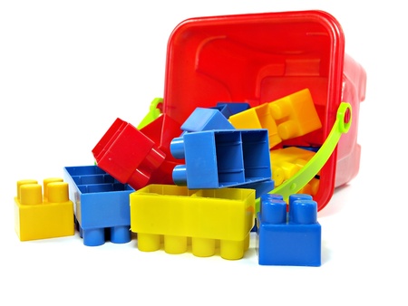 plastic building blocks in red toy pail on a white background 
  の写真素材