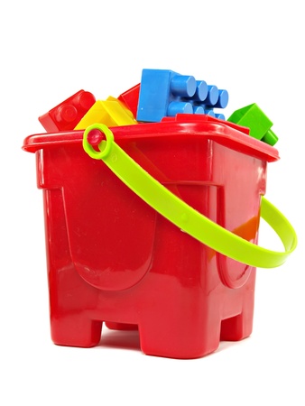 plastic building blocks in red toy pail on a white background 
  の写真素材