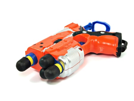 orange toy dart gun on a white background       の写真素材
