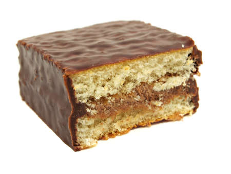 sponge cake dessert covered with chocolate on a white backgroundの写真素材