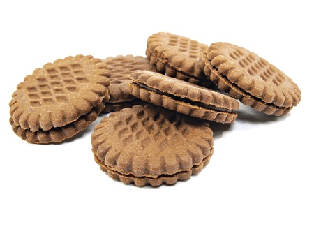 brown chocolate sandwich biscuits with cream filling on a white background 
の写真素材