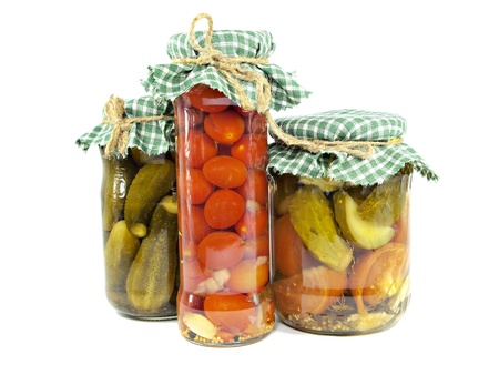 pickled cucumbers and tomatoes canned in glass jar on a white background 
   の写真素材