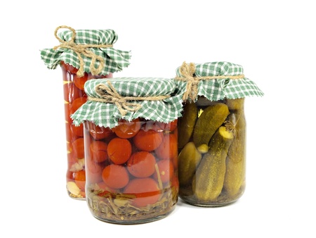 pickled cucumbers and tomatoes canned in glass jar on a white background 
   の写真素材