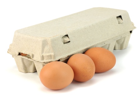 Eggs in paper box on a white background     の写真素材
