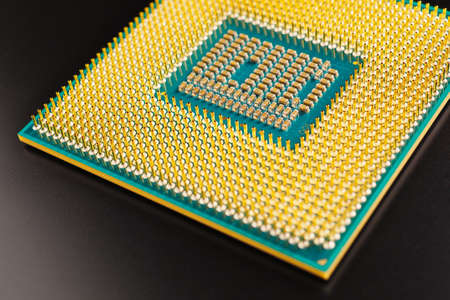 Processor microprocessor CPU of a desktop or laptop lies on dark matte surface. close-up. Semiconductors, pins and connectors. IT. illustration: computer hardware. Macroの写真素材