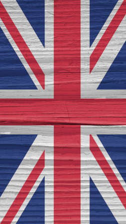 Fragment of British flag on a dry wooden surface. natural vertical background. Mobile phone wallpaper made of old wood. The official symbol of the Great Britain. Solar lighting with hard shadowsの写真素材