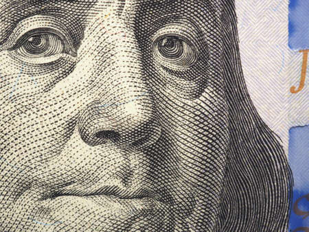 Franklin's face in close-up on a hundred dollar bill fragmentの写真素材