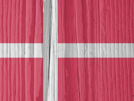 The flag of Denmark on a dry wooden surface, cracked with age. Light pale faded paint. Background, wallpaper or backdrop with Danish national symbol. Scandinavian cross. Annual rings of old woodの写真素材