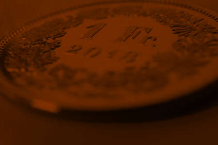 1 Swiss Franc coin closeup. Dark brown background or wallpaper on an economic, business or banking theme. Money and Central Bank in Switzerland. Macroの写真素材