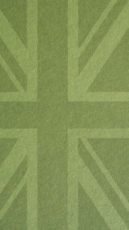 British flag outline on green cardboard surface. Paper texture with cellulose fibers. mobile phone wallpaper. Light olive paperboard backdrop. vertical background. Symbol of the Great Britainの写真素材