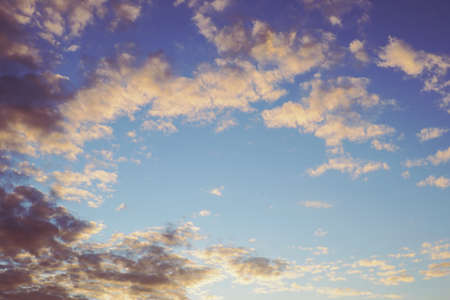 Blue sky, light and dark clouds at sunset. Cloudscape background or backdrop. natural wallpaper. end of a sunny dayの写真素材