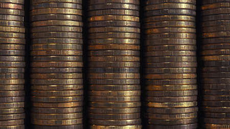 Stacks of coins close-up. money texture. Brown business wallpaper or background made of many coin edges. economy finance and banking. Macroの写真素材