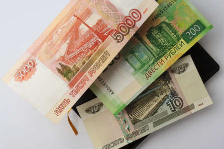 Russian banknotes are hanging in the air above the diary. The view from the top. close up