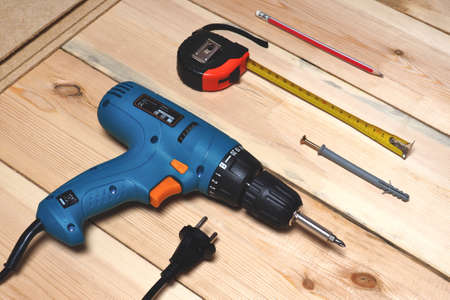 Screwdriver, roulette, pencil and planed boardsの写真素材