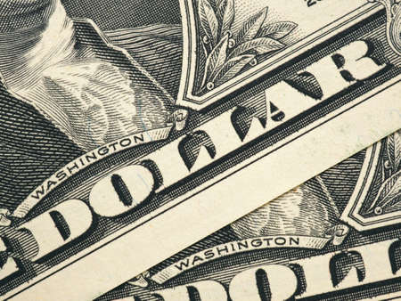 Large inscription "dollar" on the diagonal of the picture. The composition of one-dollar billsの写真素材
