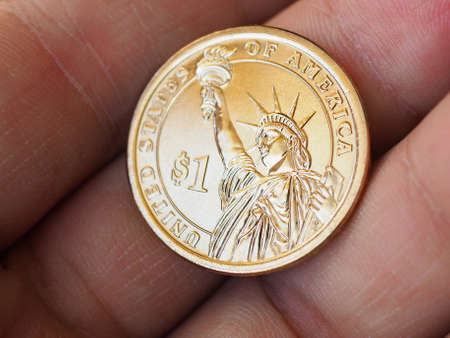American coin lies on the palm. 1 dollar coin close up. News about the national currency, the state...
