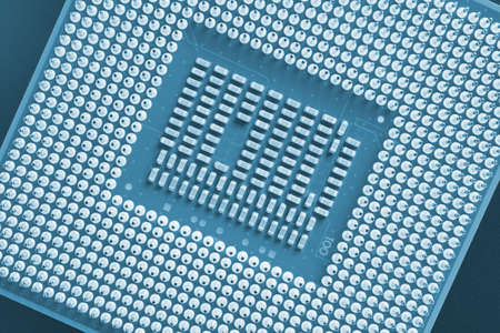 computer processor close-up. Blue tinted background or wallpaper. top view. Backdrop on the theme of IT technology and pc parts. A pattern of contacts and semiconductors. Macroの写真素材