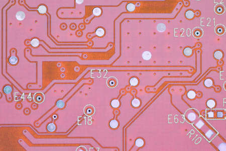 Hard drive HDD printed wiring board PWB close-up. conductive patterns. Pink PC background. Tinted computer wallpaper about science and digital technologies. Strong macroの写真素材