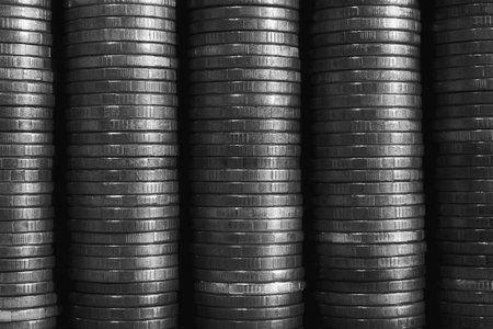 stacks of coins closeup. coin texture. Black and white business background. Wallpaper made of many coin edges. economy finance and banking. Macroの写真素材