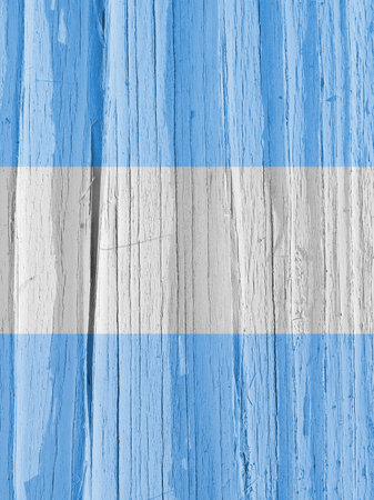 The flag of Argentina on dry wooden surface, cracked with age. Vertical background, wallpaper or backdrop with Argentine national symbol. Light pale faded paint on old wood. hard sunlight with shadowsの写真素材