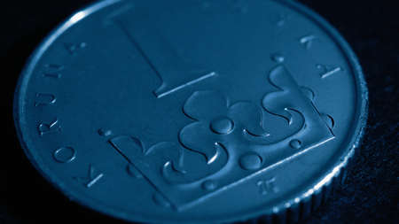 Translation: 1 Czech crown. National currency of Czechia. Blue tinted economy wallpaper. Czech one crown coin close-up. Dark background for news about money or finance of Czechia. Macroの写真素材