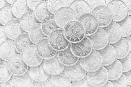 The surface of many Japanese coins in 1 yen. Monochrome black and white background or wallpaper. Information about the economy, finance, banks of Japan. view from above. Macroの写真素材