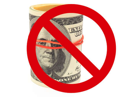 Prohibition sign on 100 dollar bills. Notes are rolled up, pulled together with an elastic band and stand on a white background. not isolated. Restriction on the use of US foreign currencyの写真素材
