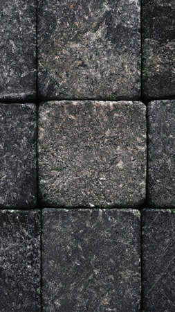 Stone mobile phone wallpaper. natural texture. Dark gray close to black backdrop. Rough surface,...