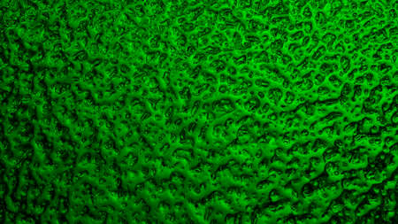 Bright green winter background. The surface of ice frozen on the window pane. An abstract pattern with a metallic sheen, like streams of mercury. rich vivid wallpaper. close-upの写真素材