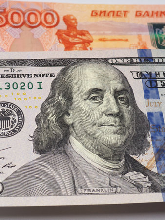 ruble and dollar. Russian 5000 ruble banknote and American 100 dollar note close-up. Vertical...