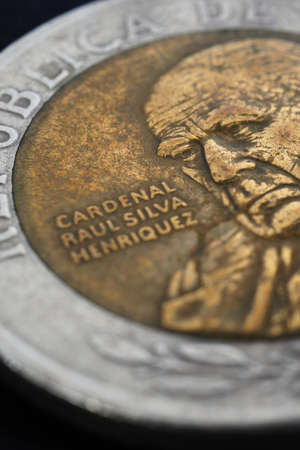 Translation: Republic of Chile. Coin of 500 Chilean pesos close-up. Peso of Chile. News about...