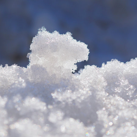 Melting snow in early spring in March. Sunny bright day. The beginning of the warm season, the end of winter. Snowdrift close-up. square shot. Macroの写真素材
