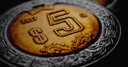 Coin of Mexican 5 five pesos close up. Peso of Mexico. News about economy or banking. Loan and credit. Wages and money. Focus on peso symbol sign. Dark horizontal stories. Macroの写真素材