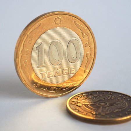 Kazakh money. A coin in 100 tenge stands on a white background. Coin of a new sample of 2019 of...