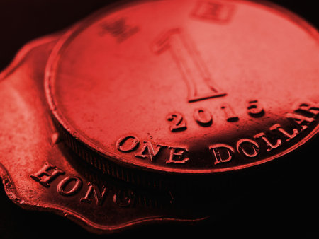 1 one Hong Kong dollar. Fragment of textured coin. Red tinted background on the theme of economics or banking. Coins and money of Hong Kong. News about the exchange rate or inflation. Macroの写真素材