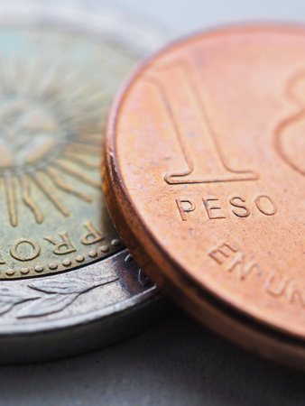 Coin of 1 Argentine peso close-up. One peso coins of Argentina. News about economy or currency. Loan and credit. Money and taxes. Focus on the word peso. vertical illustration. Macroの写真素材
