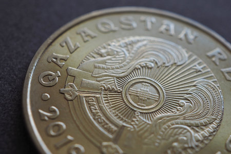 Translation of the inscription: Kazakhstan. Kazakh 50 tenge coin with the country's emblem and focus on shanyrak. Background or wallpaper on an economic theme. Transition to the Latin alphabet. Macroの写真素材