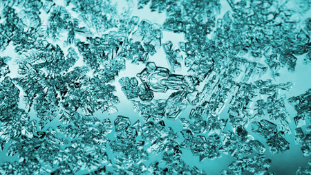 Ice crystals close-up on a window glass in winter. Tinted turquoise translucent background or...