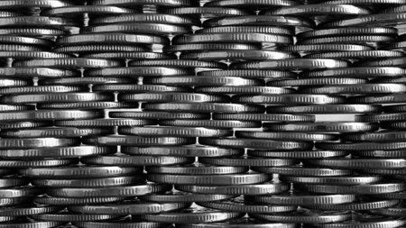 money wall. Chaotic pile of coins closeup. Nickel coin texture. Business background made of many coin edges. Economy finance and bank wallpaper. Tax and credit. black and white. Macroの写真素材