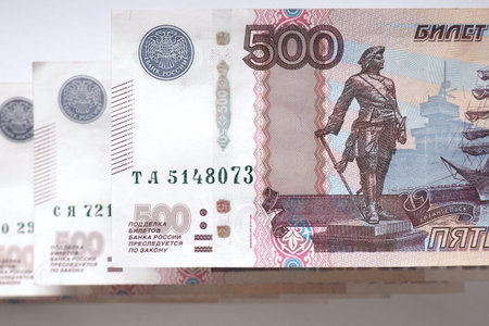 Five hundred rubles Russian banknotes laid out by a ladder on a white paper background. view from above. Macroの写真素材