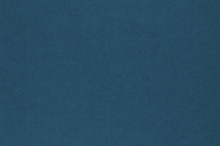 Dark blue colored paper texture. Tinted background. textured backdrop. Large patterned surface. Fibers and irregularities are visible. top-downの写真素材