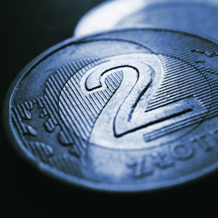 Translation: 2 zloty. Fragment of Polish two zloty coin close up. National currency of Poland. Dark blue tinted square illustration for news about economy or finance. Money and inflation. Macroの写真素材