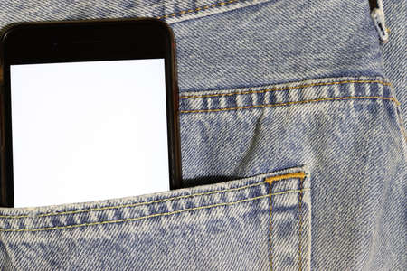Mock up white screen phone peeping out of the pocket of light blue jeans. Template for design. Denim...