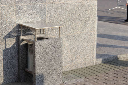 Stone trash bin. Free space for text and content. Concept of garbage collection in an urban environment.の写真素材