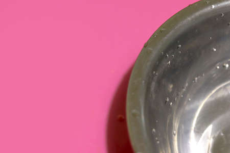 Silver metal plate close-up on a light pink background with copy space.の写真素材